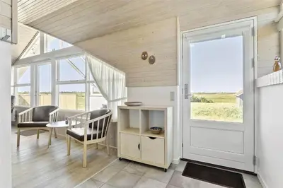 a living room with a door and a table and chairs at 807-Thisted-Grarisvej-13 in Thisted