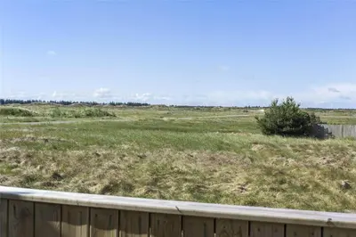 a field of grass with a wooden fence at 807-Thisted-Grarisvej-13 in Thisted