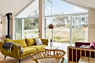 a living room with a yellow couch and chairs at 192-Snedsted-Sarasvej-12 in Snedsted