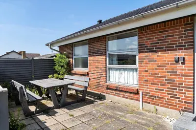 a picnic table and bench in front of a brick building at 219-Thisted-Fiskervej-16 in Thisted