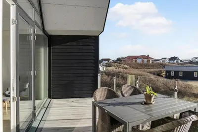 a patio with a table and chairs on a balcony at 1302-Thisted-Havstokken-30-1 in Thisted