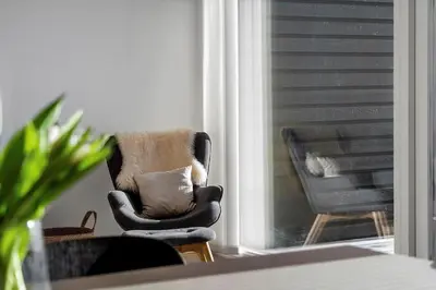 a living room with a rocking chair and a window at 1302-Thisted-Havstokken-30-1 in Thisted