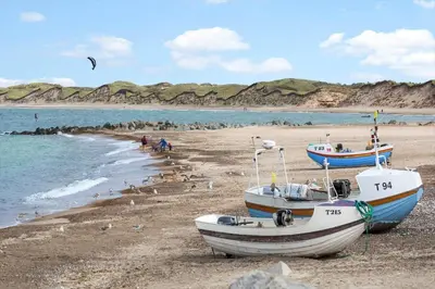 two boats sitting on a beach near the water at 1302-Thisted-Havstokken-30-1 in Thisted