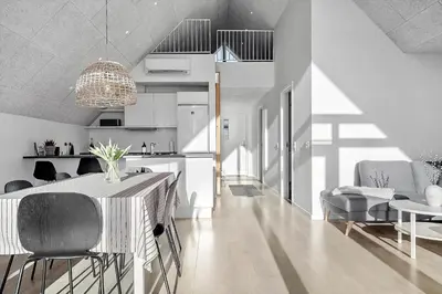 a kitchen and dining room with a table and chairs at 1302-Thisted-Havstokken-30-1 in Thisted