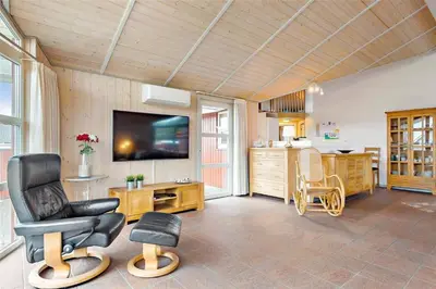 a living room with a chair and a television at 841-Thisted-Tunvej-7-A in Thisted