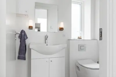 a white bathroom with a sink and a toilet at 167-Thisted-Vesterhavsgade-158 in Thisted