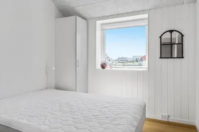 a white bedroom with a bed and a window at 167-Thisted-Vesterhavsgade-158 in Thisted
