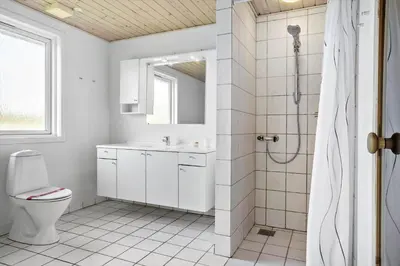 a white bathroom with a toilet and a shower at 916-Thisted-Spanggardsvej-59 in Torsted