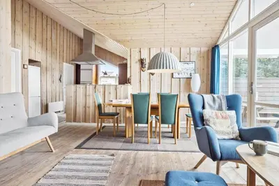 a living room with a dining room table and chairs at 916-Thisted-Spanggardsvej-59 in Torsted