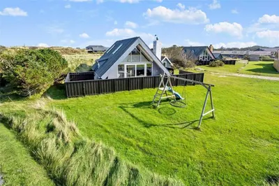 a small house in a field with a swing at 1007-Thisted-Mombak-7 in Torsted