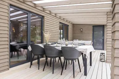 a dining room table with chairs on a patio at 157-Thisted-Isfuglevej-17 in Thisted