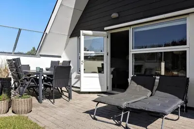 a patio with a table and chairs in front of a house at 332-Thisted-Kristinesvej-32 in Thisted