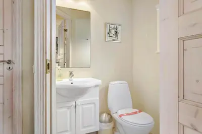 a bathroom with a white toilet and a sink at 870-Thisted-Nordsovej-34 in Thisted