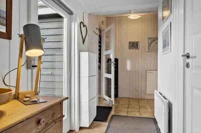 a hallway with a white refrigerator in a house at 1059-Klitmoller-Mollebakken-56 in Klitmøller