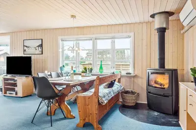 a living room with a table and a wood stove at 388-Thisted-Hummervej-8 in Thisted