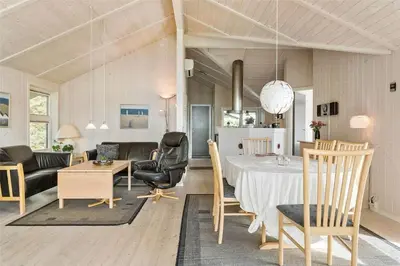a dining room and living room with a table and chairs at 858-Thisted-Delfinvej-24 in Thisted