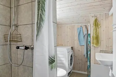 a bathroom with a toilet and a sink and a shower at 596-Thisted-Blabaervej-15 in Thisted