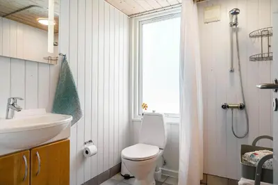 a bathroom with a toilet and a sink and a shower at 209-Vestervig-Isfuglevej-15 in Vestervig