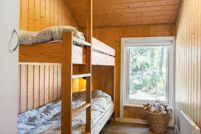 a bedroom with bunk beds in a wooden cabin at 209-Vestervig-Isfuglevej-15 in Vestervig