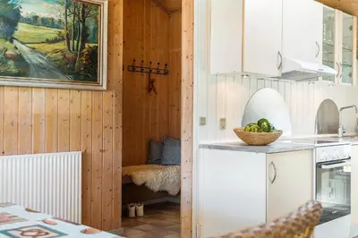 a kitchen with white cabinets and a bowl of fruit on a counter at 209-Vestervig-Isfuglevej-15 in Vestervig