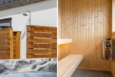 a bathroom with a tub and a wooden wall at 1300-Thisted-Smedevej-3-B in Thisted