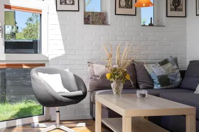 a living room with a couch and a chair and a table at 420-Vestervig-Kanalvej-4 in Vestervig