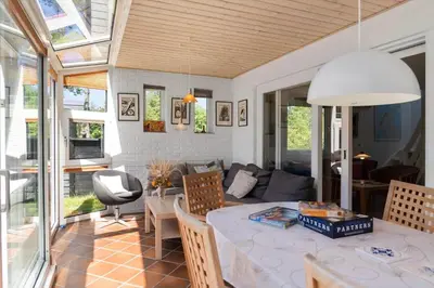 a dining room and living room with a table at 420-Vestervig-Kanalvej-4 in Vestervig