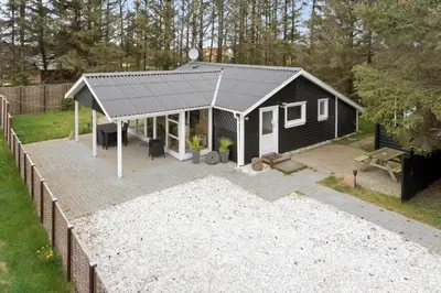 a black and white shed with a picnic table and bench at 862-Thisted-Nordsovej-162 in Thisted