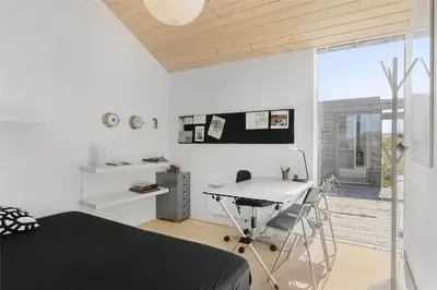 a bedroom with a bed and a desk and a window at 768-Snedsted-Somaerkevej-68 in Snedsted