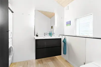 a bathroom with a sink and a washing machine at 768-Snedsted-Somaerkevej-68 in Snedsted