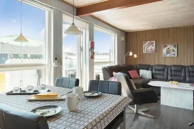 a living room with a table and chairs and a couch at 586-Thisted-Havbovej-30 in Thisted