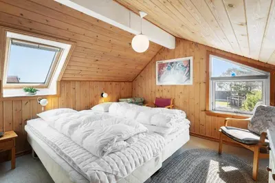 a bedroom with a large white bed in a wooden room at 675-Thisted-Tunvej-15 in Thisted