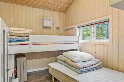 a room with two bunk beds and a window at 1030-Thisted-Lyngstien-15-A in Torsted
