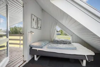 a bed sitting under the stairs of a house at 446-Thisted-Nordsovej-206-F in Thisted