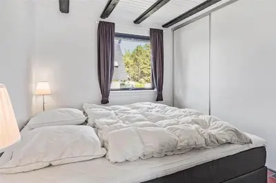 a large white bed in a white room with a window at 142-Thisted-Pighvarvej-4 in Thisted