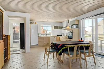 a kitchen with a table and chairs in a kitchen at 133-Thisted-Jorgen-Hedes-Vej-10 in Thisted
