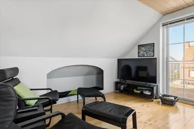 a living room with black chairs and a flat screen tv at 133-Thisted-Jorgen-Hedes-Vej-10 in Thisted