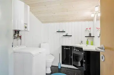 a white bathroom with a toilet and a sink at 710-Thisted-Klitrosevej-10 in Thisted