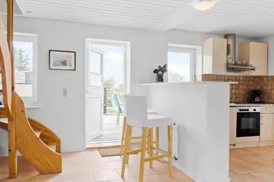 a kitchen with white walls and a table and chairs at 822-Thisted-Bredkaervej-8 in Thisted
