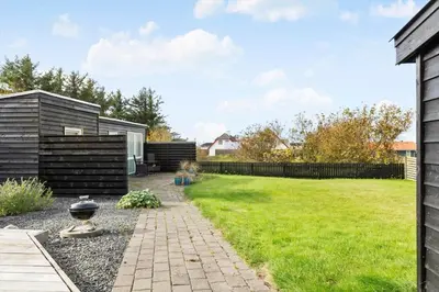 a backyard with a lawn and a fence at 822-Thisted-Bredkaervej-8 in Thisted