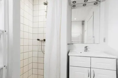 a white bathroom with a sink and a mirror at 822-Thisted-Bredkaervej-8 in Thisted