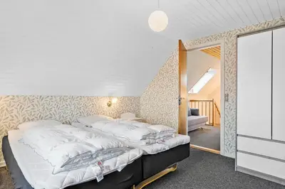 a bedroom with a large bed with white sheets at 172-Thisted-Fiskervej-72 in Thisted