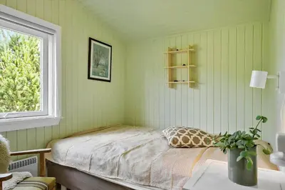 a green bedroom with a bed and a window at 576-Thisted-Klemsvej-26-E in Thisted