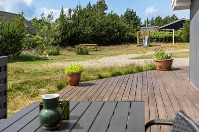 a patio with a table and potted plants on it at 576-Thisted-Klemsvej-26-E in Thisted