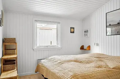 a white bedroom with a bed and a window at 576-Thisted-Klemsvej-26-E in Thisted