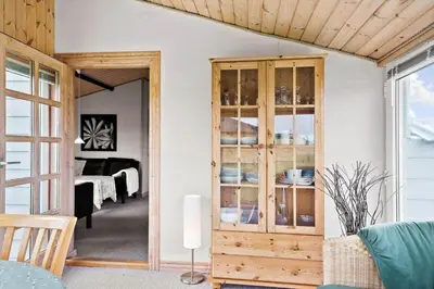 a room with a wooden cabinet with dishes in it at 276-Thisted-Nordsovej-76 in Thisted