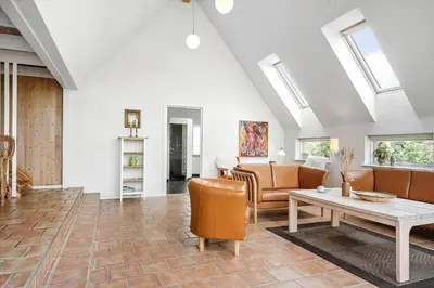 a living room with a couch and a table at 186-Vestervig-Magevej-5 in Vestervig
