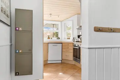 a kitchen with a white refrigerator and a window at 1050-Thisted-Spanggardsvej-5 in Torsted