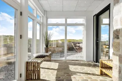 a living room with large windows and a couch at 1053-Thisted-Kraenhavs-Sti-8 in Torsted