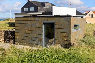 a brick building with a door in a field at 1053-Thisted-Kraenhavs-Sti-8 in Torsted